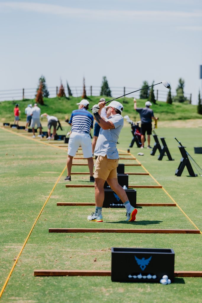 Image of golfers at Kickingbird Golf Club's driving range in Oklahoma